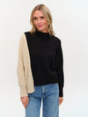 Colorblock uneven hem sweater featuring a stylish black and cream design, perfect for casual layering in Long Island boutique fashion.