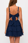 Navy blue back tie mini dress featuring a triple-layered ruffled skirt and adjustable straps, perfect for Long Island boutique fashion.