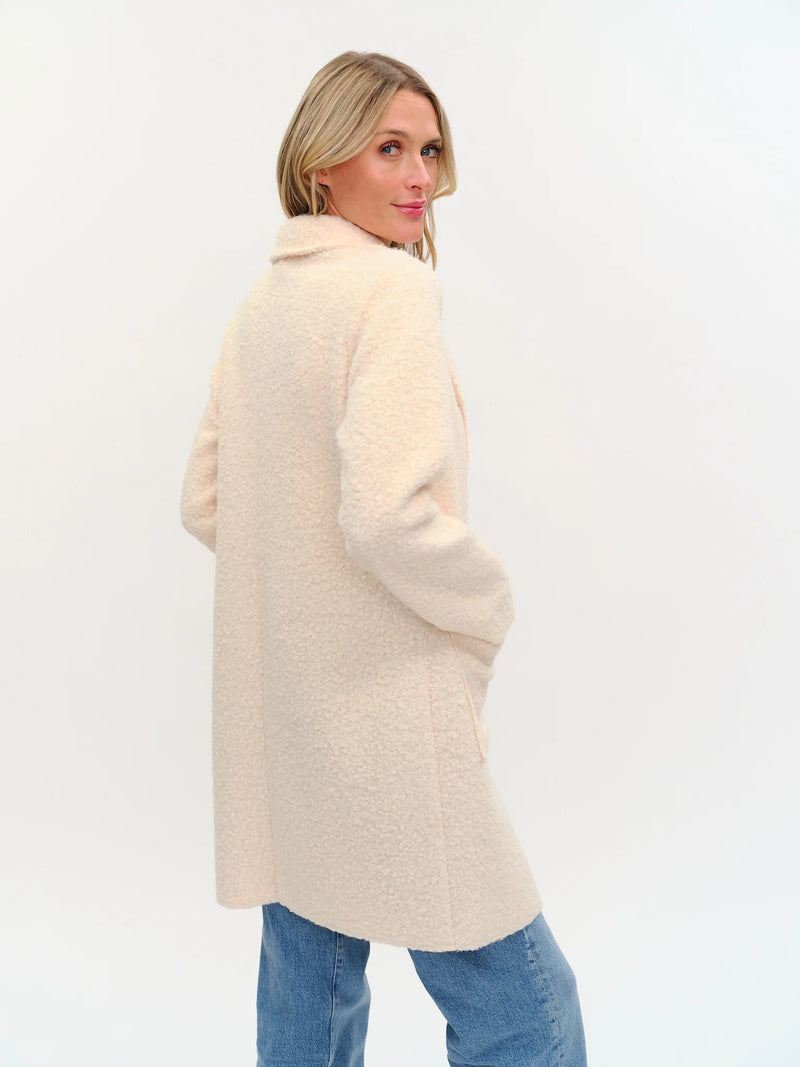 Light beige faux shearling long coat with a relaxed fit and collar, perfect for cozy layering in Long Island boutique fashion.