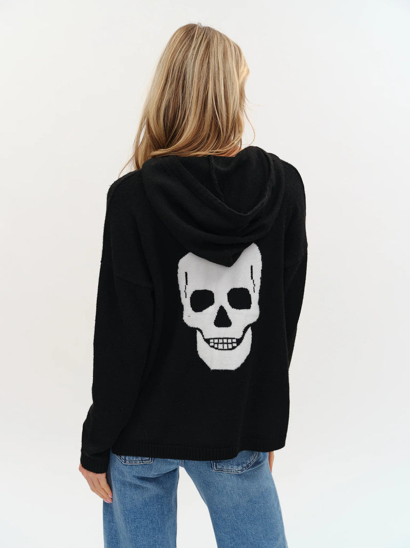 Cozy black hoodie featuring a bold white graphic skull design on the back, perfect for stylish layering from this Long Island boutique fashion.