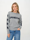 Soft heather gray sweater featuring a "GAMEDAY" graphic and navy star details on the sleeves, perfect for Long Island boutique fashion enthusiasts.