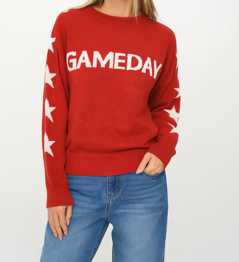 Cozy red sweater featuring bold "GAMEDAY" lettering and star patterns on sleeves, perfect for Long Island boutique fashion enthusiasts.